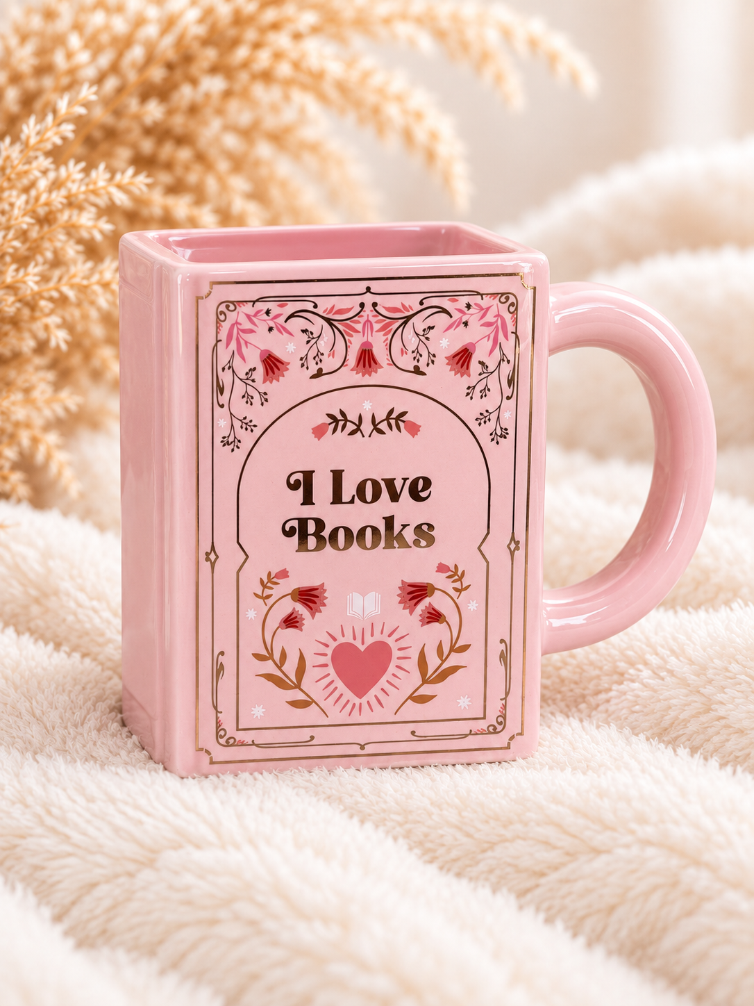 Rosa I Love Books Keramiktasse in Buchform mit floralem Motiv und Henkel auf der linken Seite