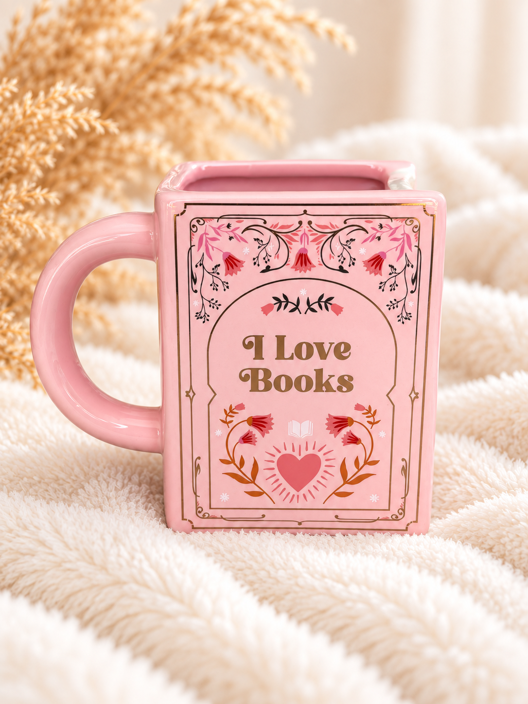 Rosa Büchertasse mit I Love Books Schriftzug, Blumenmotiv und Henkel auf der rechten Seite
